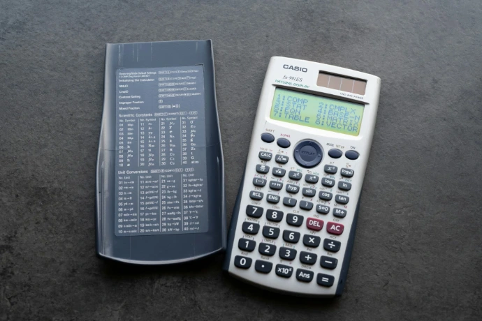 A scientific calculator with its cover open